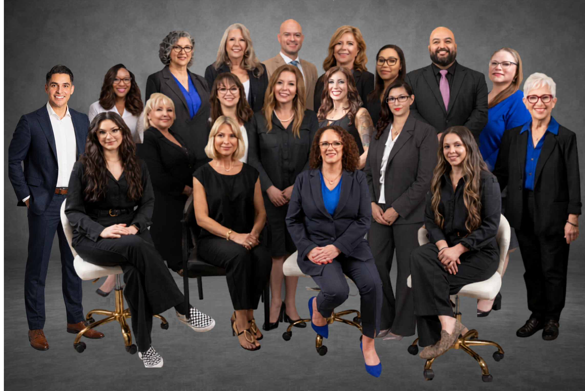 Group of diverse professionals in business attire posing together against a gray backdrop.